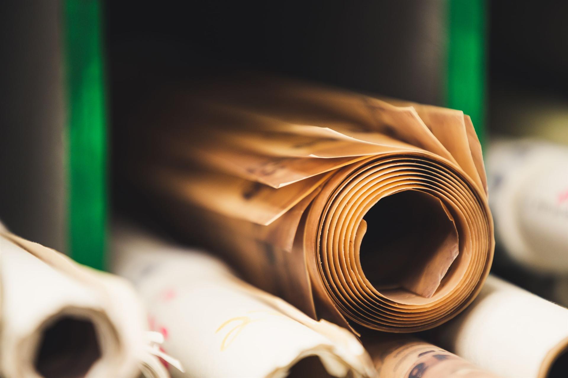 Rolls of print material in a production facility